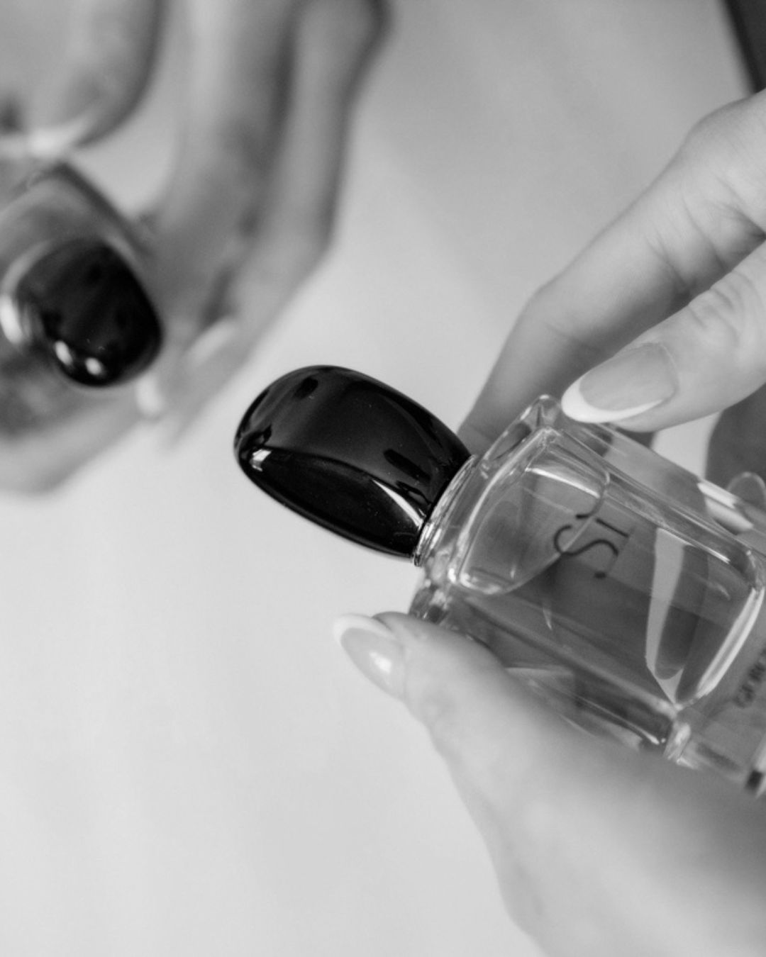 Flacone di profumo elegante nelle mani della sposa durante i preparativi nuziali